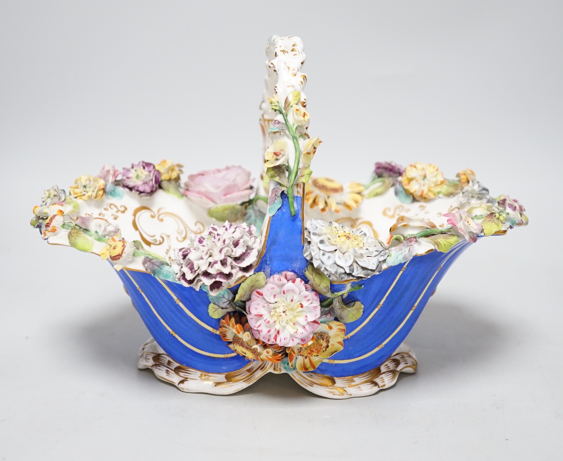 A Rockingham type floral encrusted china basket, 32cm